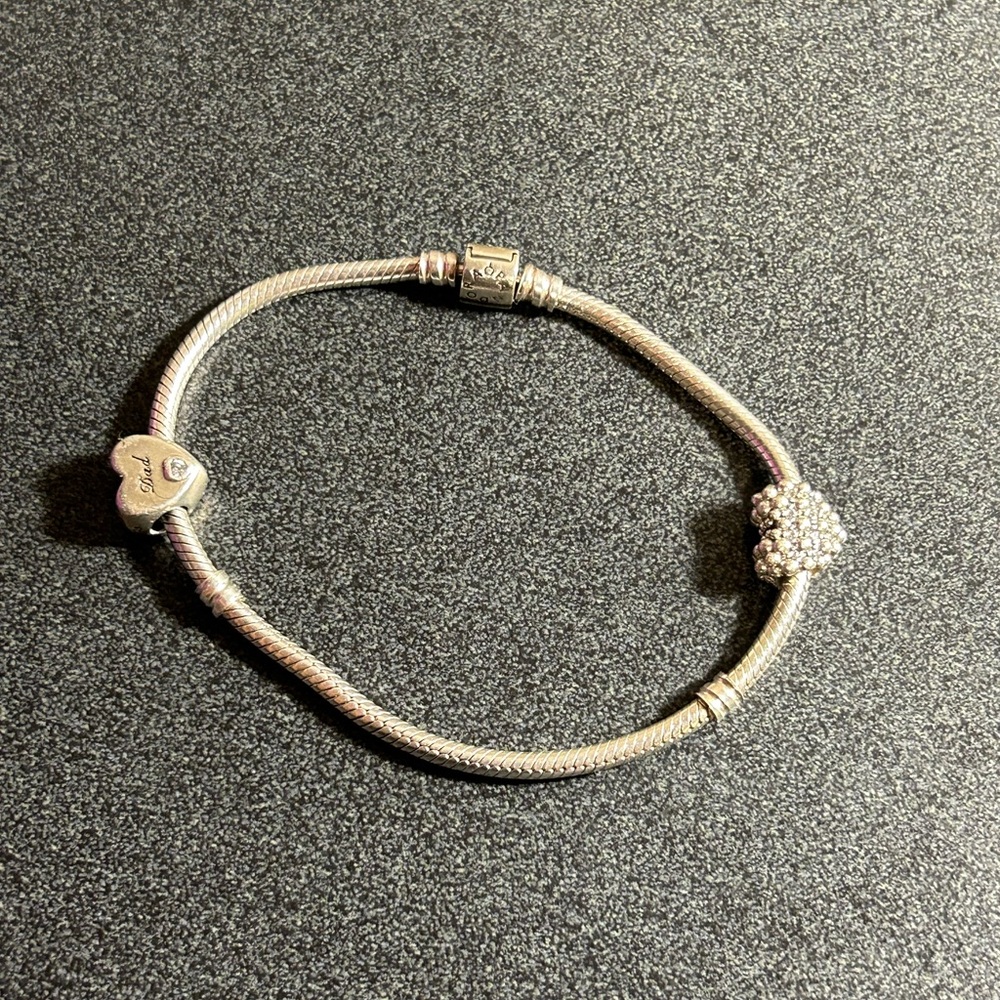 Authentic Pandora Bracelet that comes with two charms.